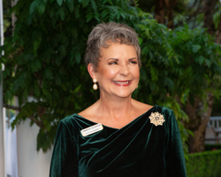 An elderly woman in nice close smiles.