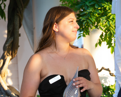 A young woman accepts an award