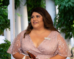 A woman smiles as she accepts an award.